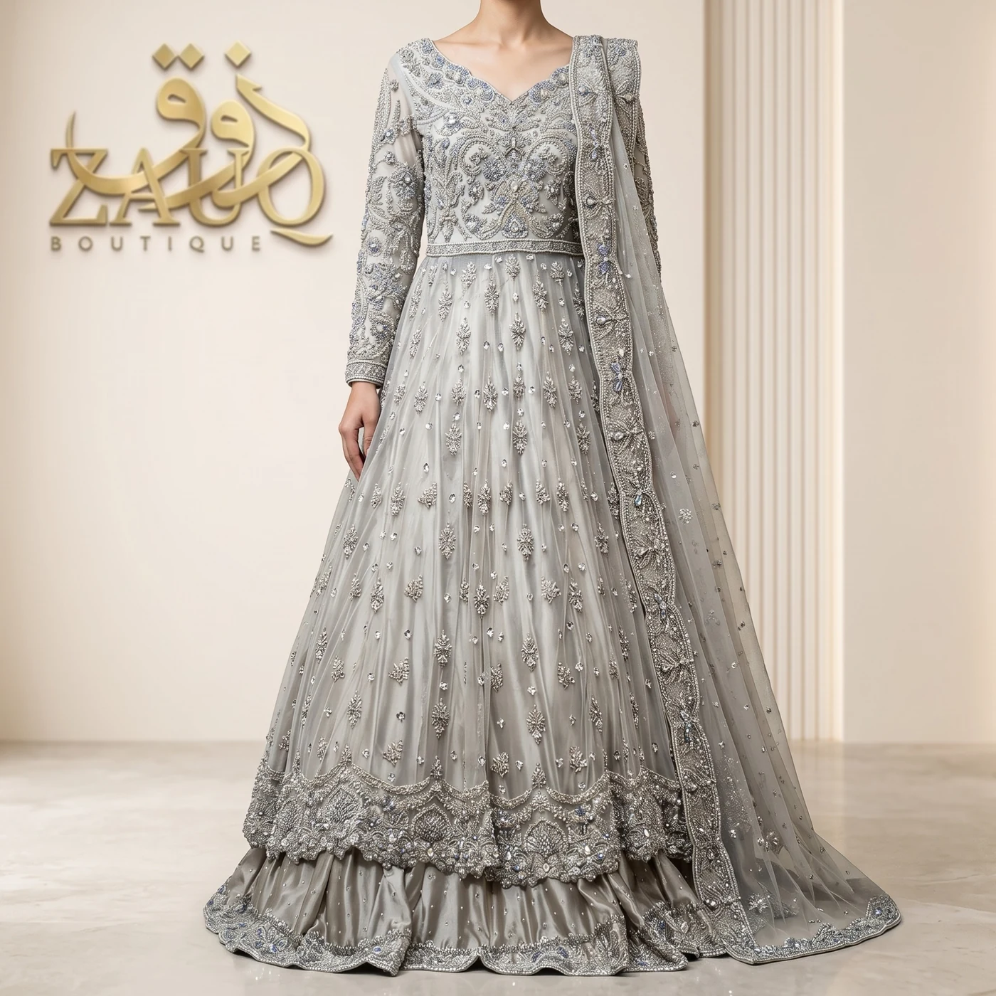 A soft grey net gown with fine silver work, for the reception.