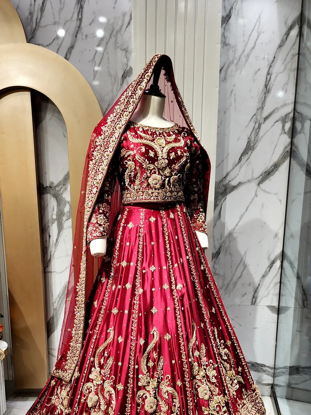 Crimson choli lehanga with heavy gold work and a matching embroidered dupatta
